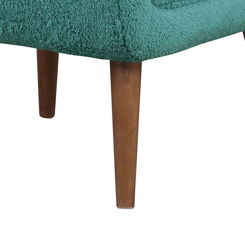Sillón decorativo verde azulado con respaldo capitoné
